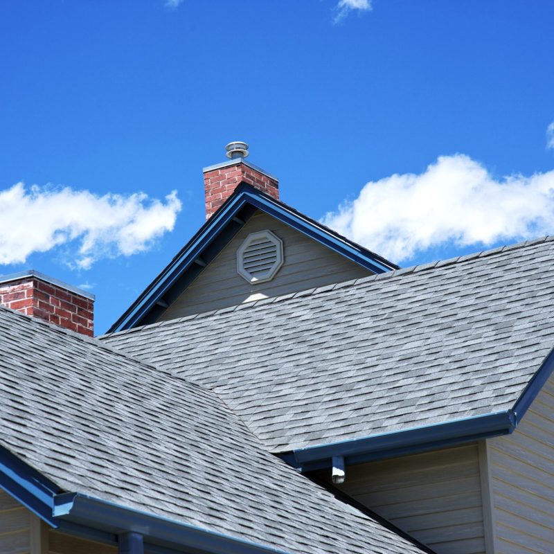 House Roof - Roofing Works. Cloudy Blue Sky. American Building Style.